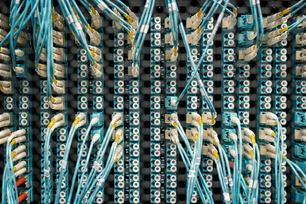 Top view of fiber optic cables connected to ports in modern data server